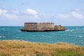 Sao Lourenco Blockhouse. San Lorenzo Island, fort nearby grassy shore and coastline of Mozambique island, Indian ocean coast.