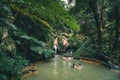 SAO MIGUEL, AZORES, PORTUGAL - JULY 29, 20189 People enjoy bath in natural thermal pools, spa of Caldeira Velha near Royalty Free Stock Photo