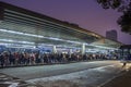 Passengers wait in line for buses at the Santana Bus Terminal at night, north side of Sao