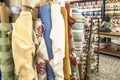 people inside of traditional fabric store with stacks of colorful textiles