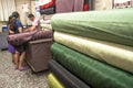 people inside of traditional fabric store with stacks of colorful textiles