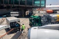 Etrobras Aviation tanker truck with fuel and workers loading luggage in the aircraft yard Royalty Free Stock Photo