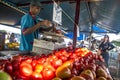 Traders sell fresh tomatoes