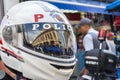 Detail of a Military Police helmet with the reflection of the shops