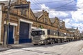 Trucks parked in front of old warehouses