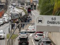 Traffic of buses, cars and pedestrians in Santo Amaro Avenue