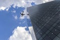 Business airliner flies over the roof of office building in Faria Lima Avenue, west side of Sao Paulo city