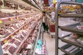 Consumers in meat section in a supermarket
