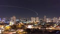 Sao Paulo city at night with airplane trail