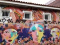 Colorful mural of street art about people cartoon with multiple flower shapes