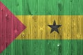 Sao Tome and Principe flag depicted in bright paint colors on old wooden wall. Textured banner on rough background