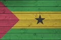 Sao Tome and Principe flag depicted in bright paint colors on old wooden wall. Textured banner on rough background