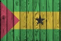 Sao Tome and Principe flag depicted in bright paint colors on old wooden wall. Textured banner on rough background