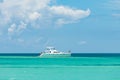 Happy tourists enjoying vacation on a yacht in turquoise Caribbean sea