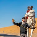 Portrait of a Berber man and his dromedary Royalty Free Stock Photo