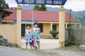 Sapa, Lao Cai, Vietnam - 08 16 2014: Two happy vietnamese schoolgirls in uniform in front of a vietnamese primary school in Sapa,