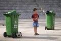 Sapa, Lao Cai, Vietnam - 08 17 2014: A vietnamese kid playing soccer as goalkeeper with a goal made with two green garbage bins in