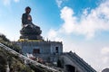 SAPA, VIETNAM - MAR 14, 2019: Giant buddha statue on the top of Fansipan mountain peak, Backdrop Beautiful view blue sky Royalty Free Stock Photo