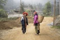 Hmong ethnic women in traditional dress on the street in mountain village in Sapa region, North Vietnam, close up