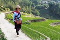 Sapa, Vietnam - May 2019: Hmong woman in traditional dress walks along rice terraces in Lao Cai province Royalty Free Stock Photo