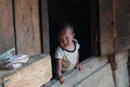 Sapa, Vietnam - May 2019: little child looking out over wooden house porch