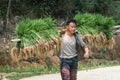 Sapa, Vietnam - May 2019: Vietnamese man carries rice planting material in Ta Van village
