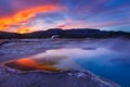 Sapphire Pool in Biscuit basin with blue steamy water and beautiful colorful sunset. Yellowstone, Wyoming