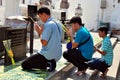 Saraburi, Thailand: Three Men Praying at Temple