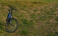 SARAI, RUSSIA-August 22, 2021: A mountain bike stands in the middle of green grass outside the city. Space for text