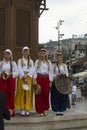 Group of traditional dressed bosnian girls in front of Sebilj fountain