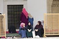 Islamic girls sit in the courtyard of Gazi husrev beg Mosque in Sarajevo