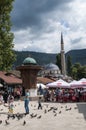 Sarajevo, Bosnia and Herzegovina, Bascarsija, Sebilj, fountain, old town, square, mosque, minaret, skyline, bazaar, market Royalty Free Stock Photo