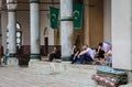 Muslims sitting outside Gazi Husrev-beg`s Madrasa Mosque, in the Bascarsija Royalty Free Stock Photo