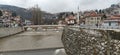 Sarajevo, Bosnia and Herzegovina - March 8, 2020: Sheher bridge over the Milatsk river. Spring. Turbid water in the river and bare