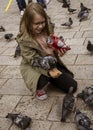 Sarajevo, Bosnia - May 2, 2022 - Young girl feeds the pigeons in a park Royalty Free Stock Photo