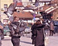 Sarajevo, Europe 09.02.2018, Young couple standing in city square holding pigeons