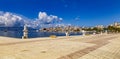 Saranda, Albania - 14 May 2021: Panoramic view of city port and town from the new modern city embankment. Modern sculptures adorn