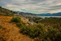SARANDA, ALBANIA: The road in the rocks and the view from above of the houses and the coast in Saranda