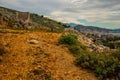 SARANDA, ALBANIA: The road in the rocks and the view from above of the houses and the coast in Saranda