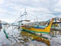 Filipino fishing boat in a sea of junk Royalty Free Stock Photo