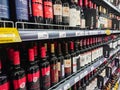 Various brands of red and pink wine on the shelves of the supermarket.