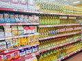 Goods on the shelf of a grocery store. Baking flour in paper bags and vegetable oil in plastic bottles.