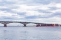 Luxury four-deck river cruise ship `Mustai Karim` on the Volga River. Automobile bridge between the cities of Saratov and Engels