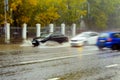 Cars drive at high speed through puddles in the rain. Blurred photography, motion effect