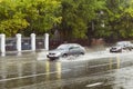 Saratov, Russia- September 03, 2021:Cars drive through puddles in the city during the rain. Bad roads in Russia. Blurred photo