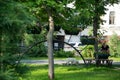 Saratov, Russia - 07/06/2020: A woman walks with her pet with a dog in a beautiful summer park among flowers and trees