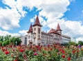 Saratov State Conservatoire. Was opened in 1912. Russia. Blooming roses in the foreground. Clouds on a blue sky