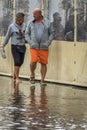 Couple walking on a flooded pavement