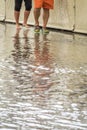 Couple walking on a flooded pavement