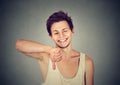 Sarcastic happy young man showing thumbs down hand gesture Royalty Free Stock Photo